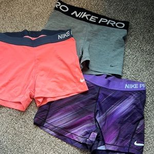 Nike spandex. Grey ones are medium. The other two are large.